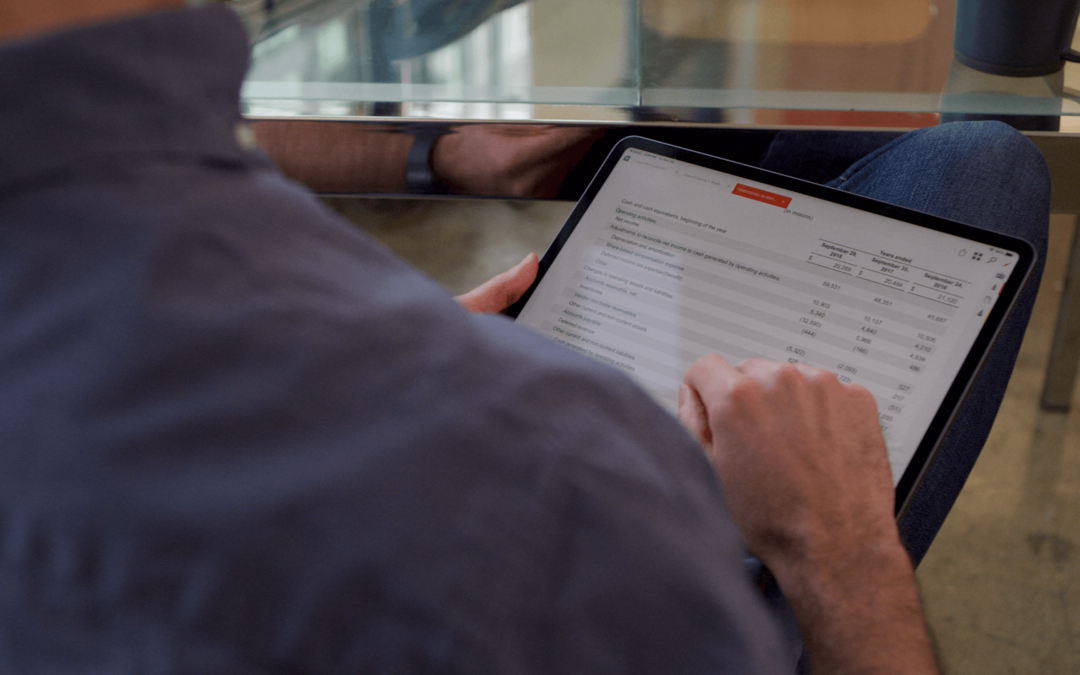 Man looking at a financial statement on a tablet