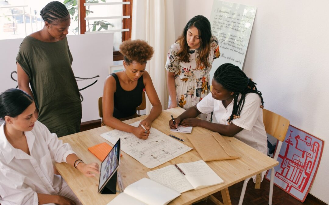 Team of Women Sitting At a Table Planning a Project